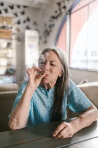 an elderly woman smoking